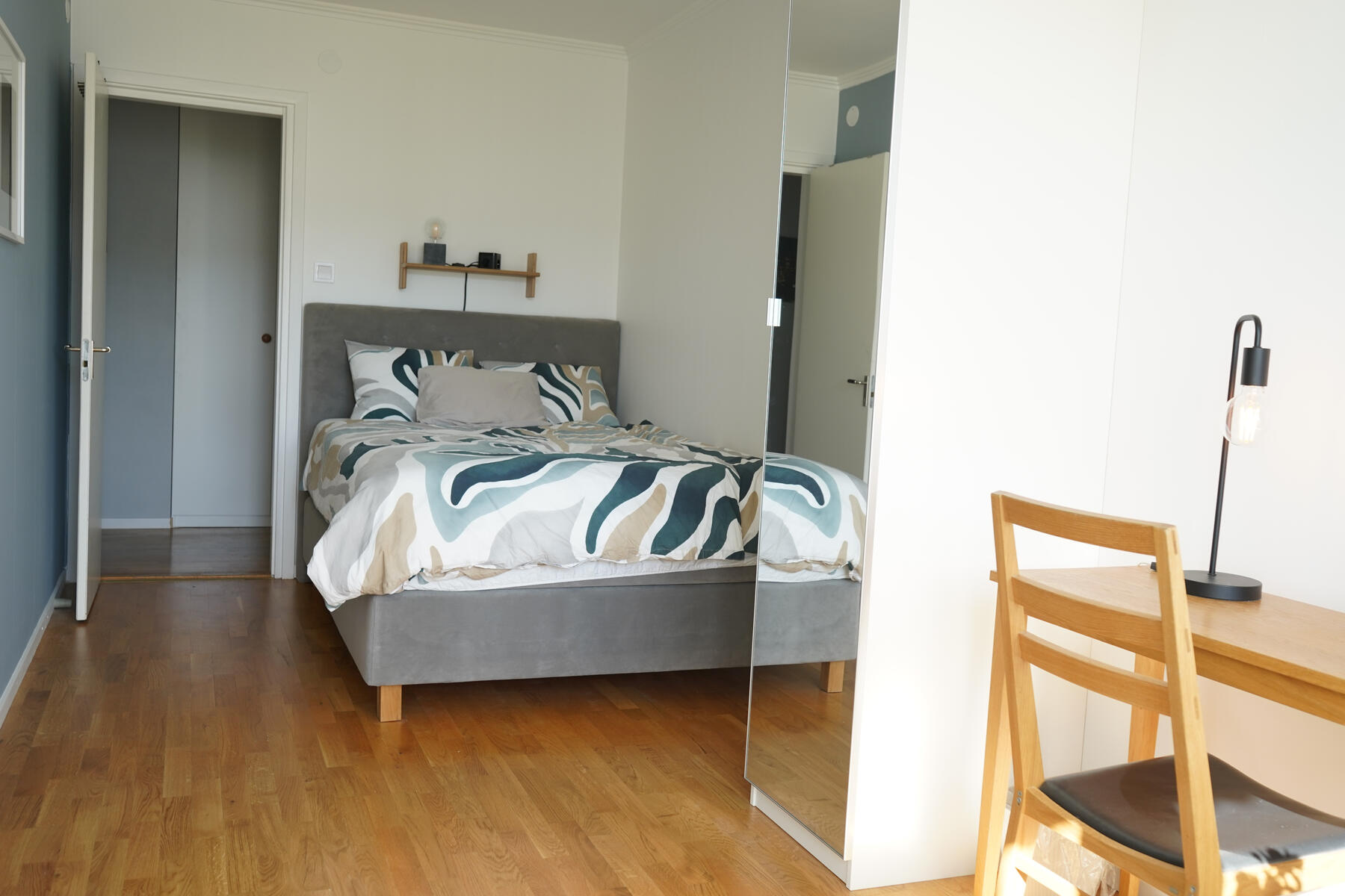 Guest bedroom with small desk, large closet and double bed